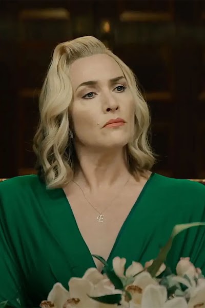 Orchid light on Elena's face: the controlled beauty of power. Cinematography at work.